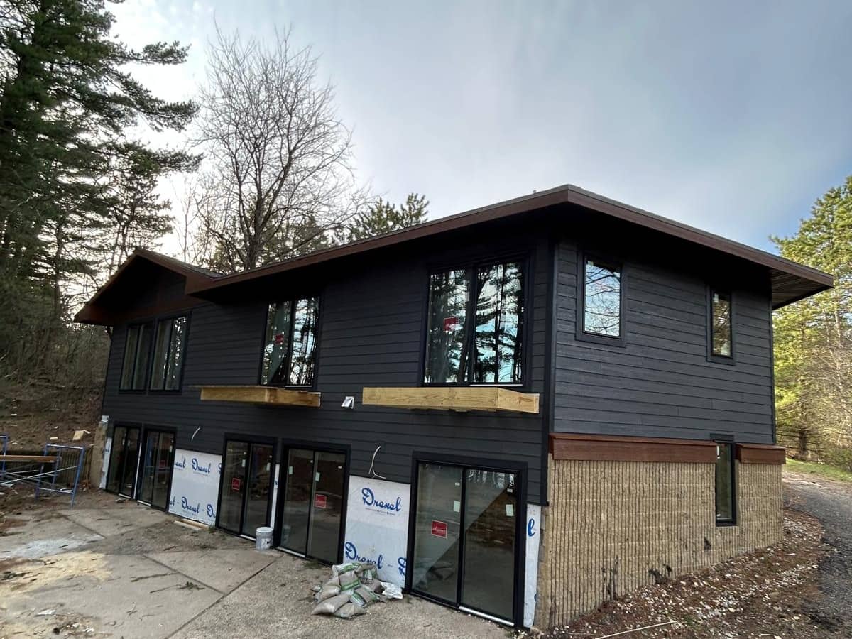 black siding installed on a large residential home
