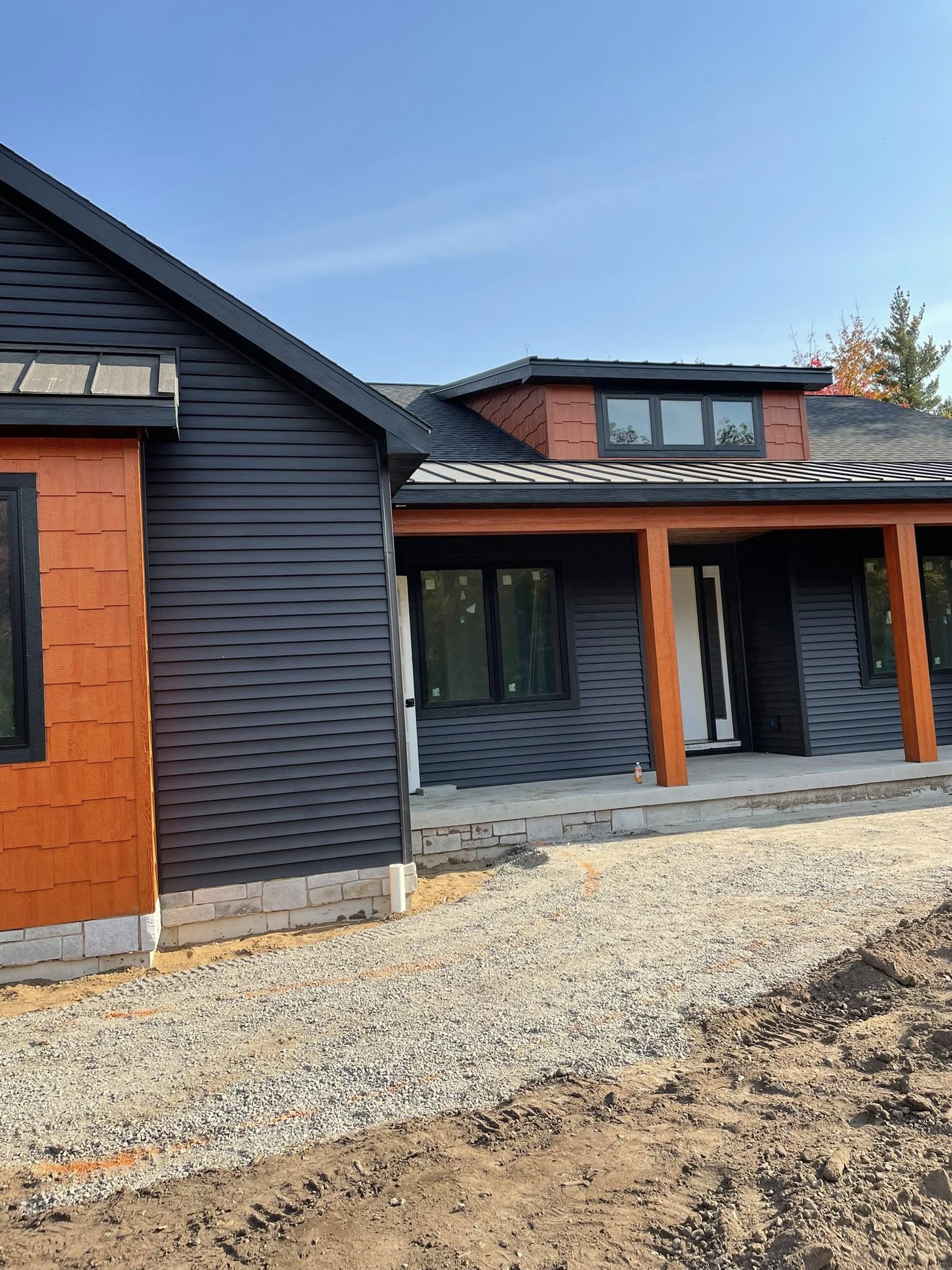 luxury dark blue home siding with vibrant orange color details
