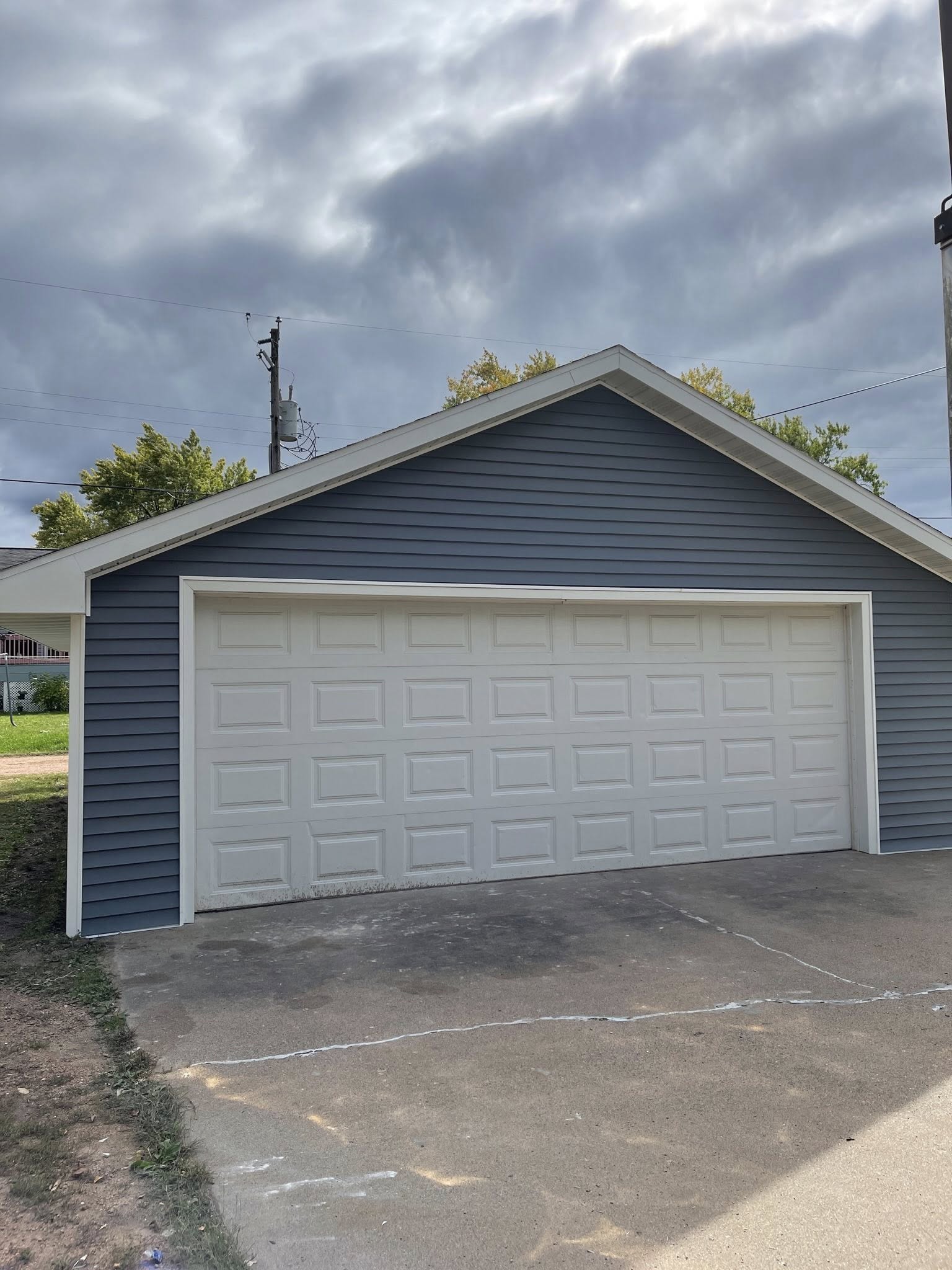 garage siding blue installation with new garage door