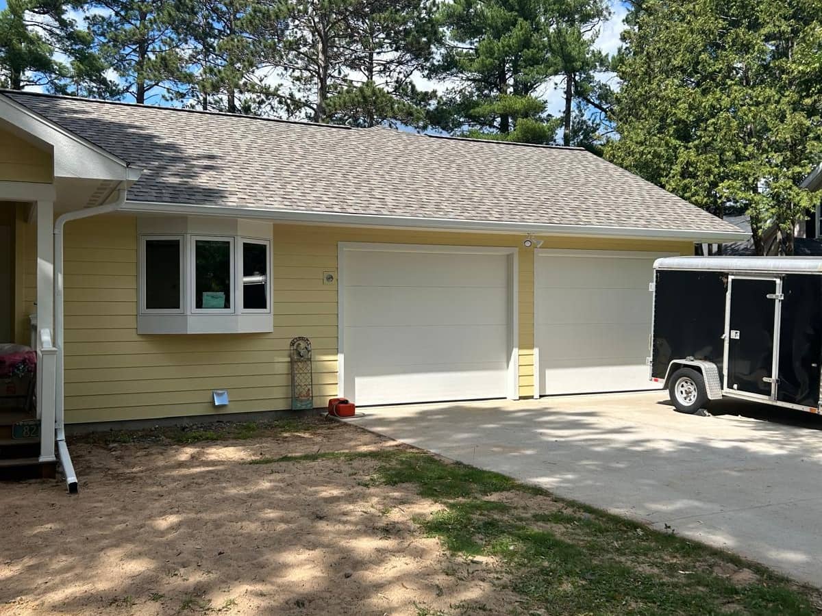 two door garage yellow siding