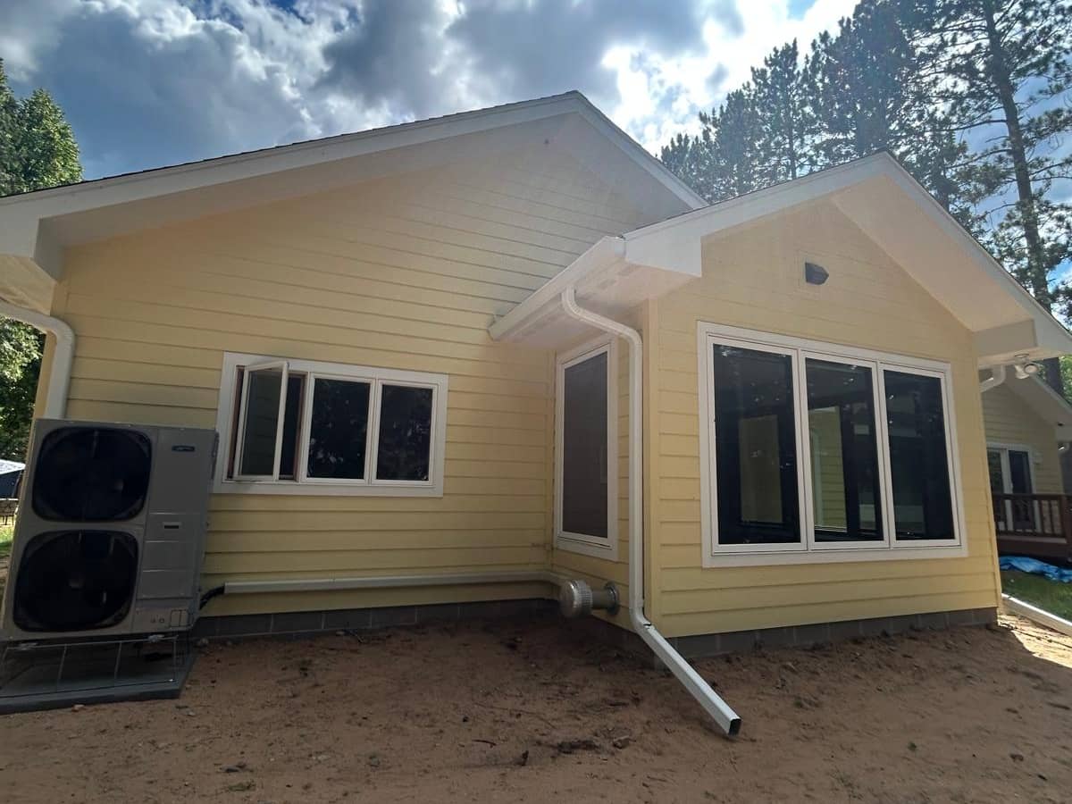 yellow siding with large windows